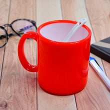 Colorful coffee mug with mixed design patterns.